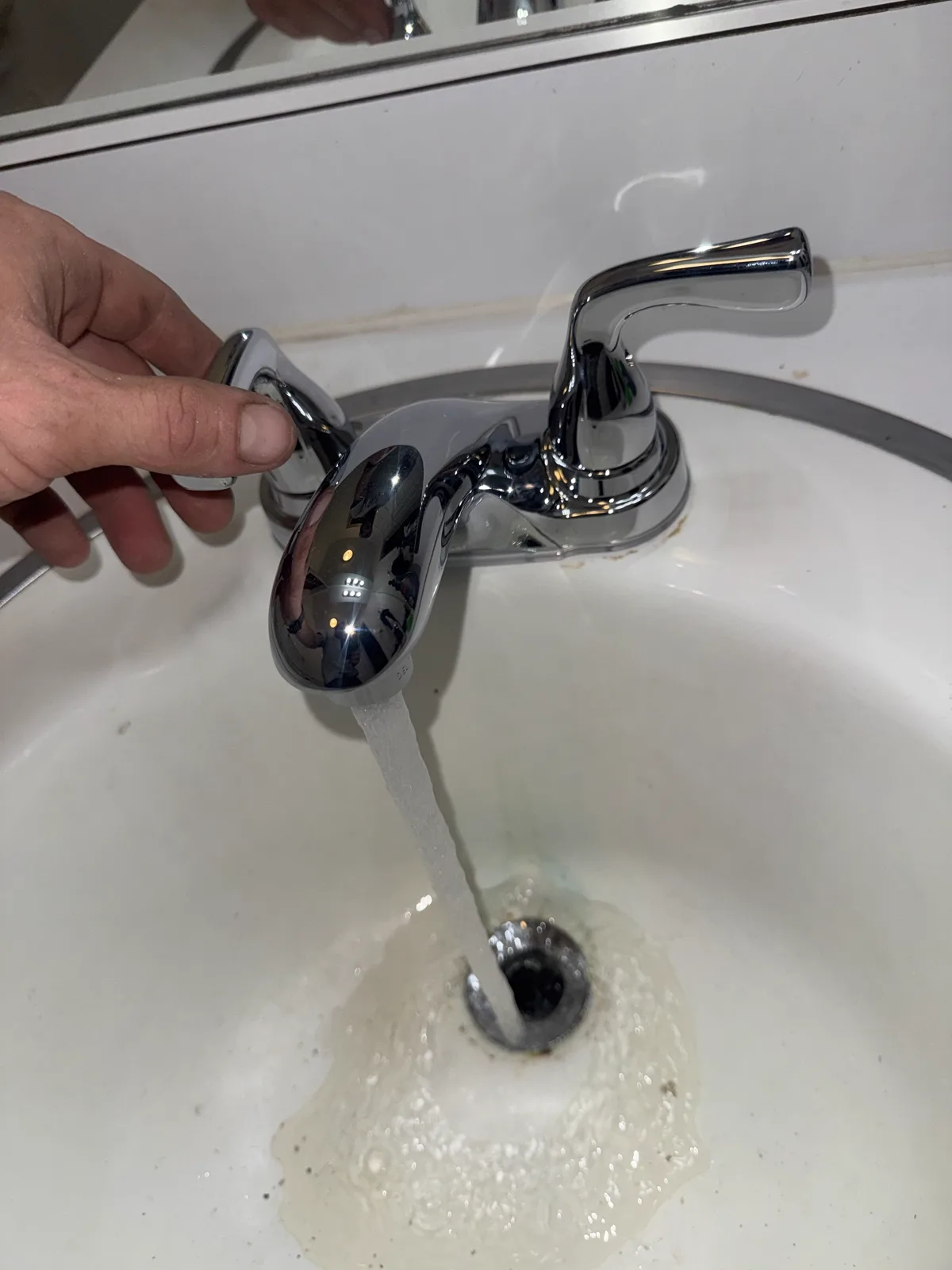 New chrome Delta bathroom sink faucet running during a function check in Southwest Oklahoma City